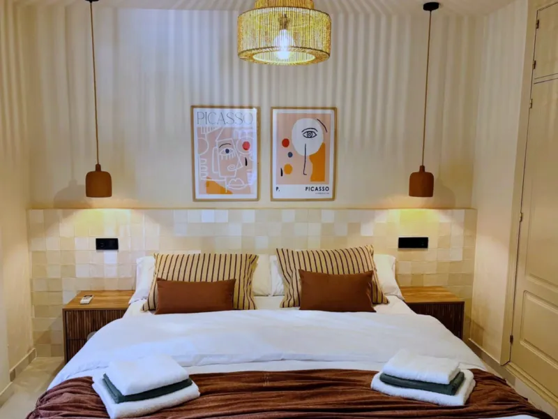 Bedroom 2 with a queen-size bed, zellige headboard and two Picasso prints