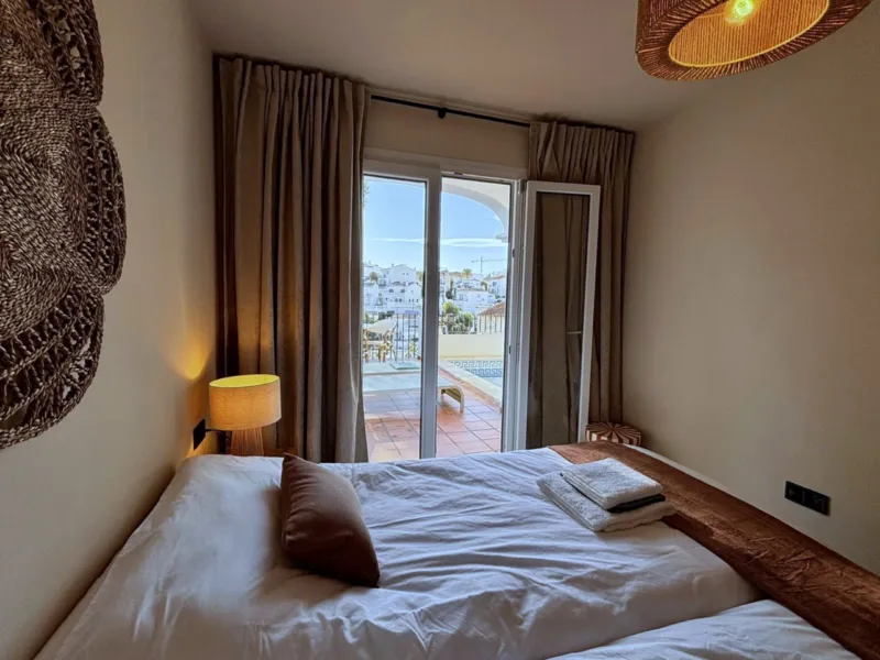 Bedroom 3 with two single beds and French doors to the terrace