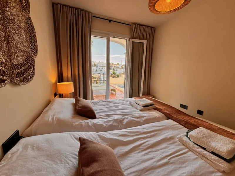 Bedroom 3 with two single beds and a view