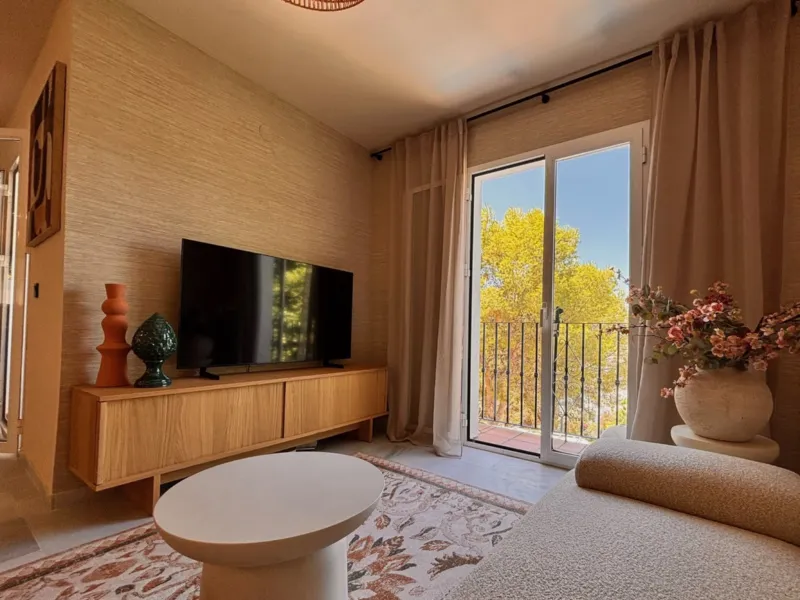 Living room with TV and balcony