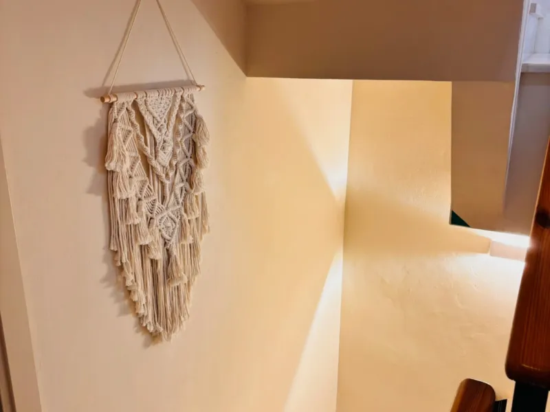 Staircase with a macramé wall hanging