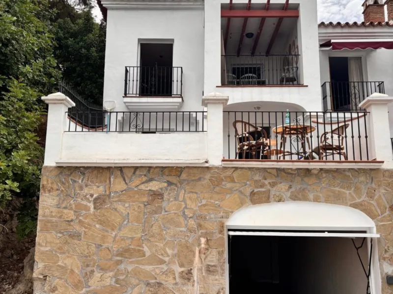 Street view of the house with the garage below