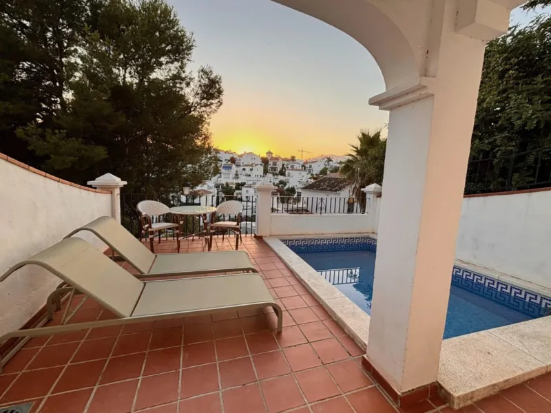 Pool terrace at sunset, looking out over the white houses of Nerja