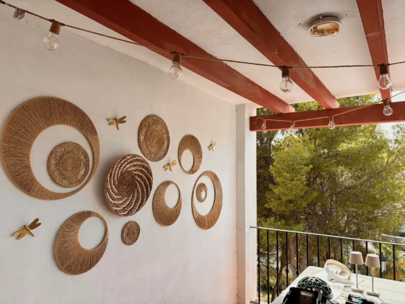 Covered terrace with woven baskets on the wall