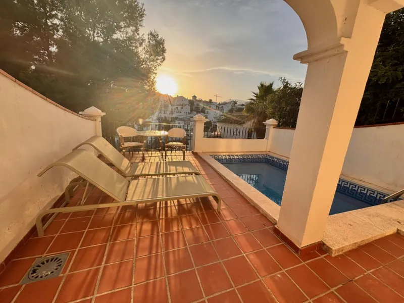 Terrace with private pool and sun loungers at sunset