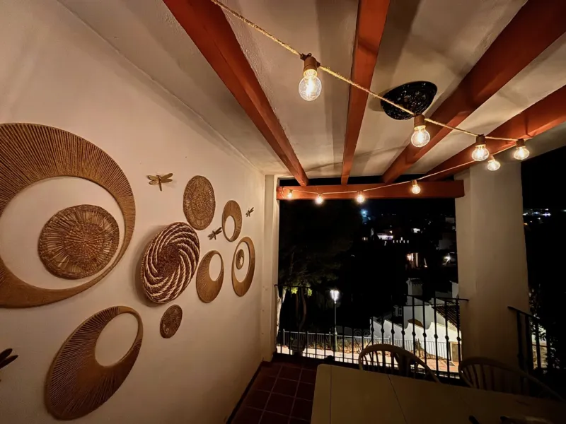 Terrace with woven wall baskets at night