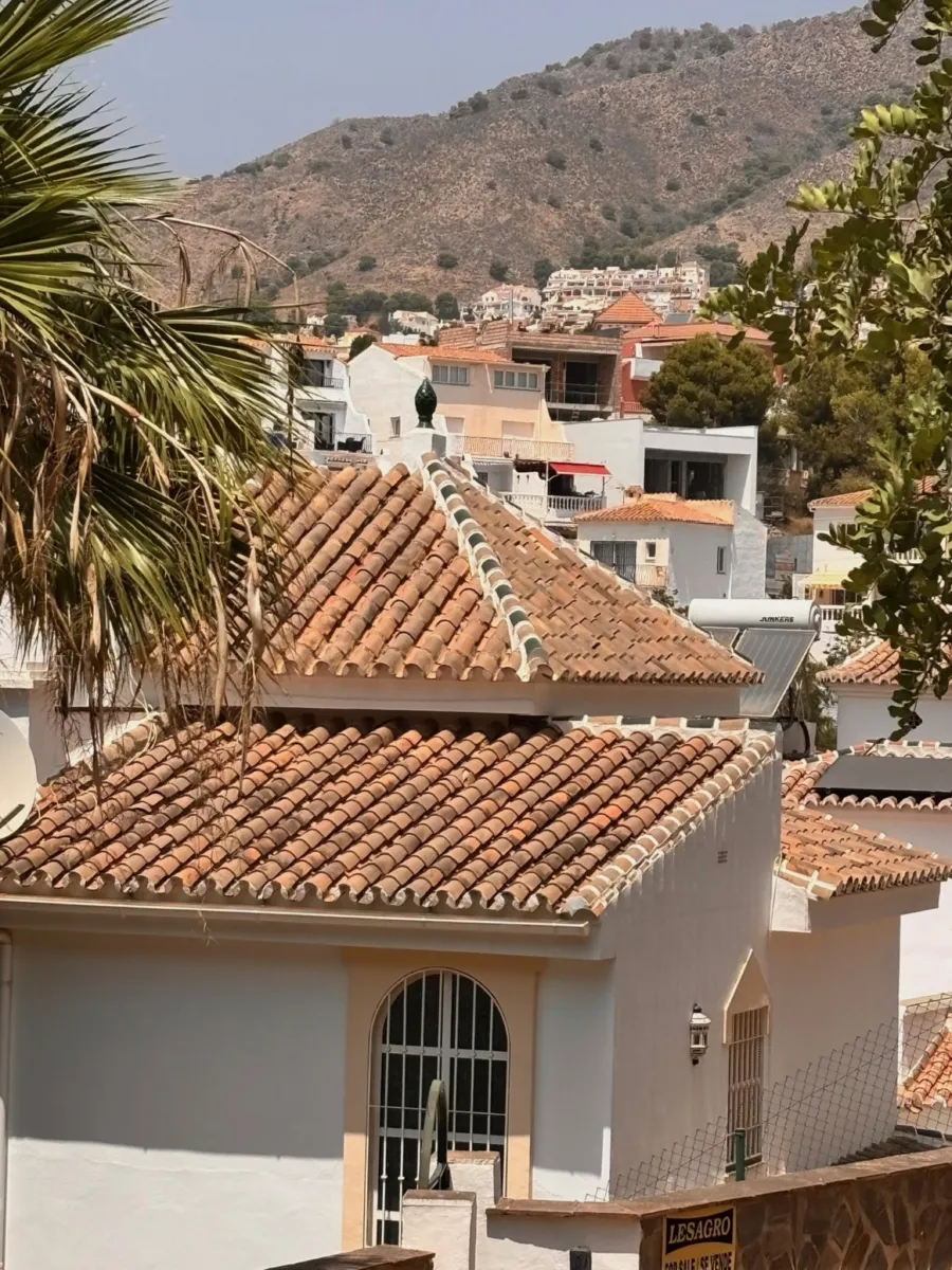 Terracotta rooftops and the mountains
