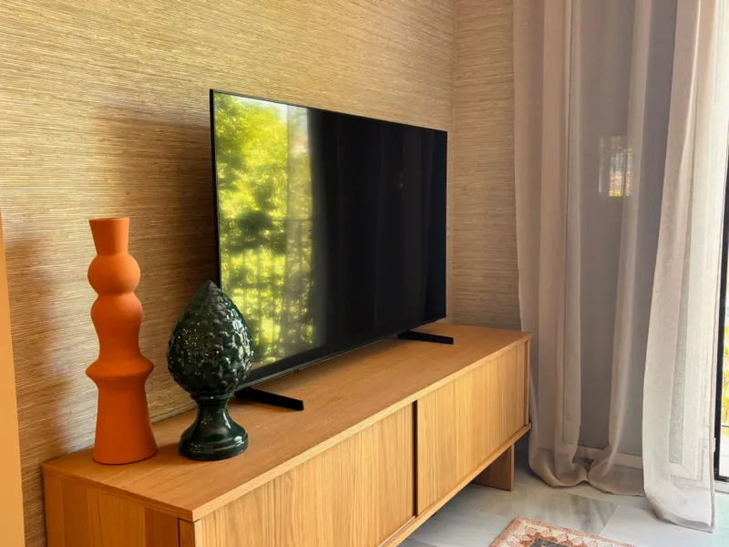 TV wall with grasscloth wallpaper