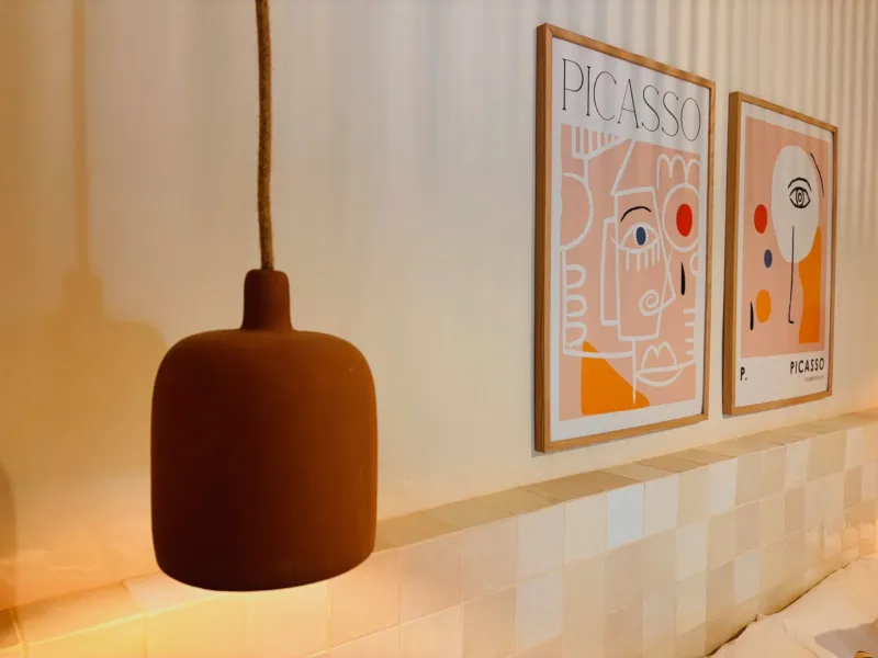Two Picasso prints and a clay pendant