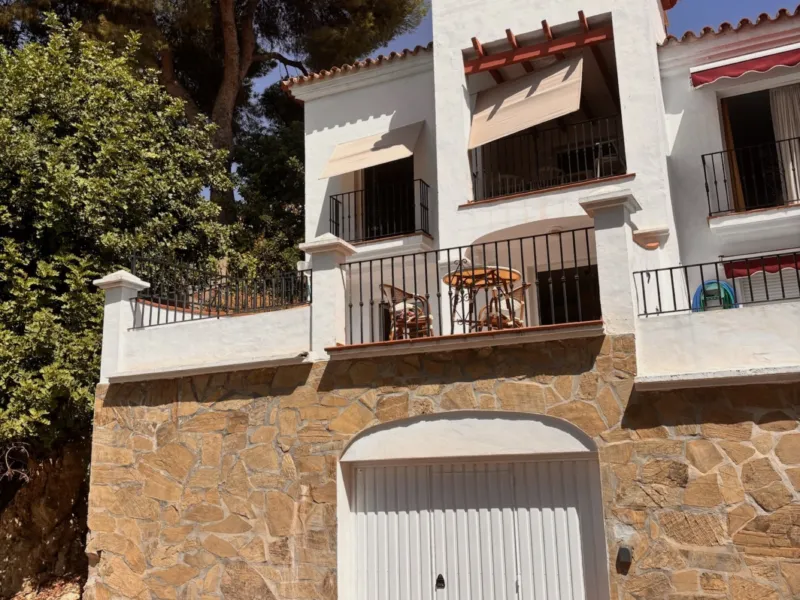 Villa Lucena from the street, above the stone garage wall
