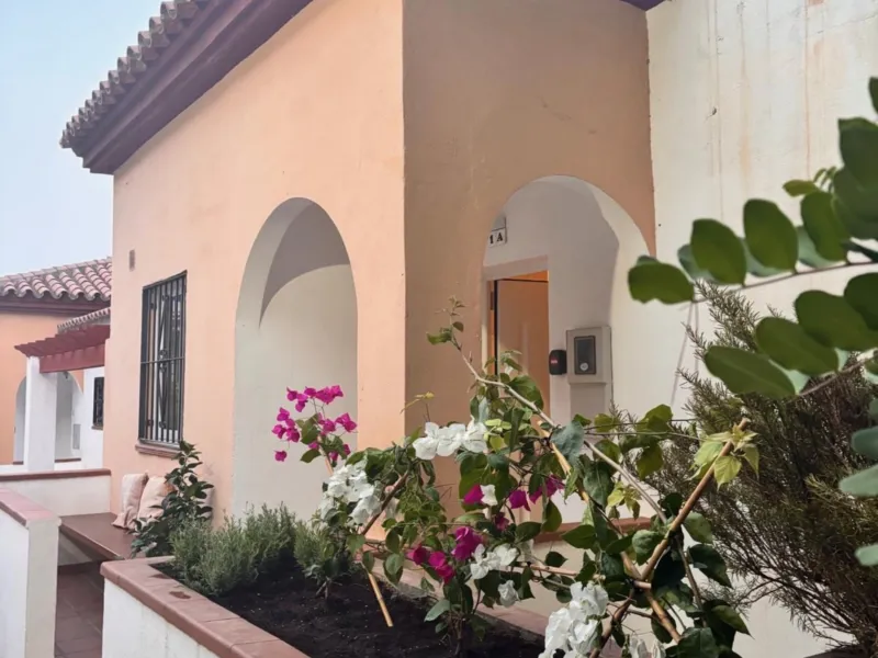 Whitewashed entrance with flowers