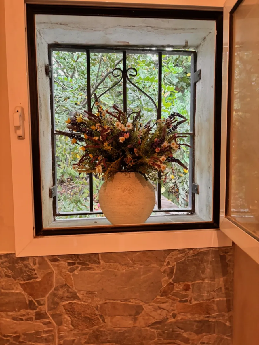 Window with a vase of dried flowers